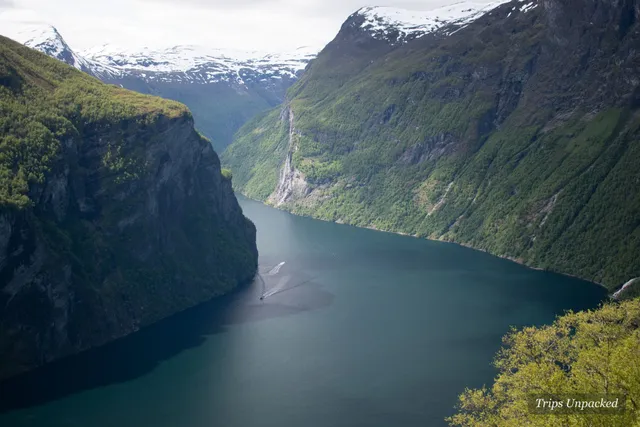 The Geirangerfjord winding between steep green mountains, seen from above
