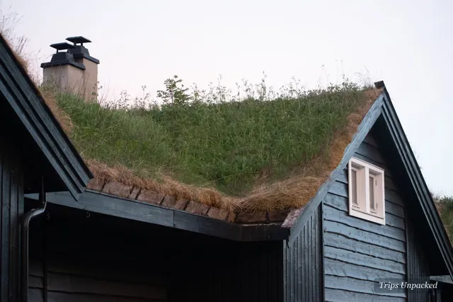 A traditional Norwegian cabin with a grass-turf roof and timber walls