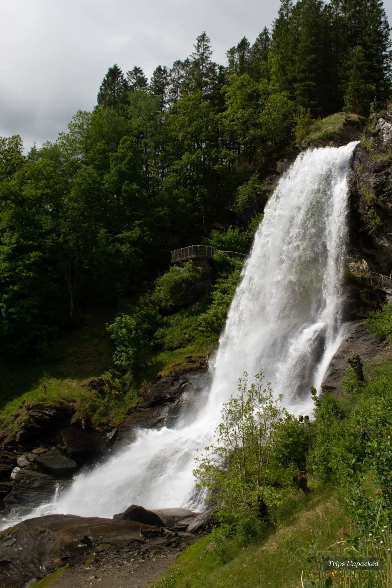 Steinsdalsfossen - a path runs directly behind the falling water.