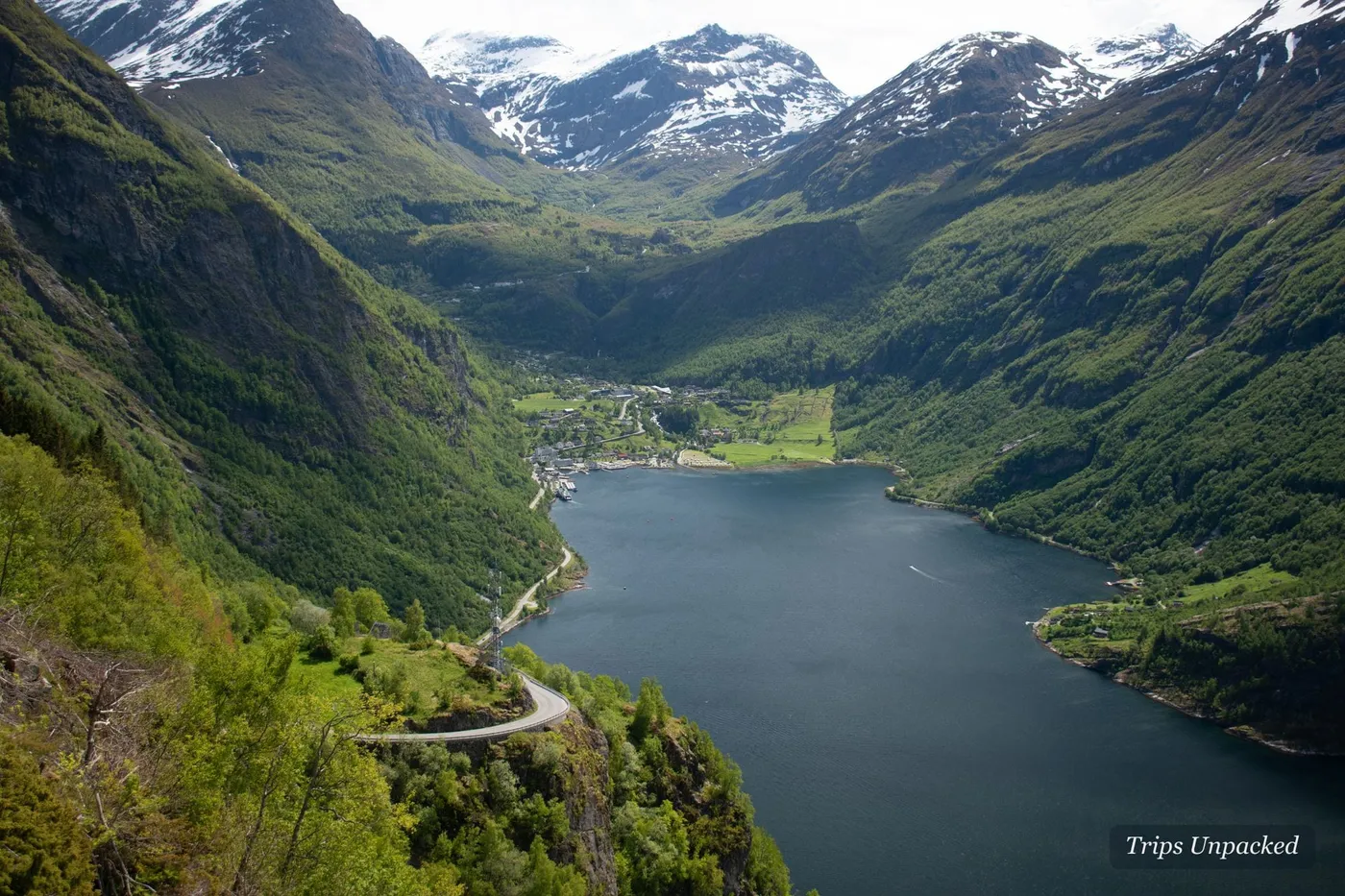 The Geirangerfjord from the Eagle Road - a hairpin bend curling above the village and snow-topped peaks.