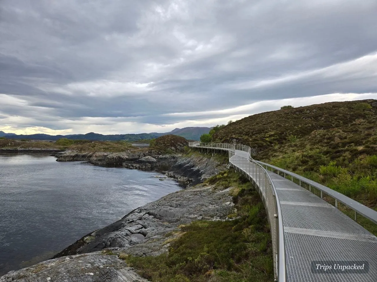 A slim viewing walkway winding across rocky islets along the Atlantic Ocean Road.