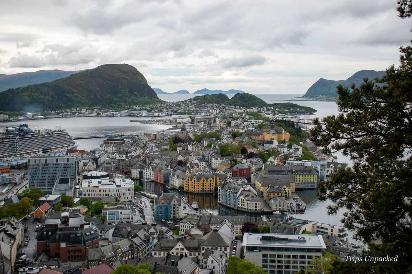 Ålesund's Art Nouveau centre across islands between the sea and surrounding peaks, from the Aksla viewpoint.