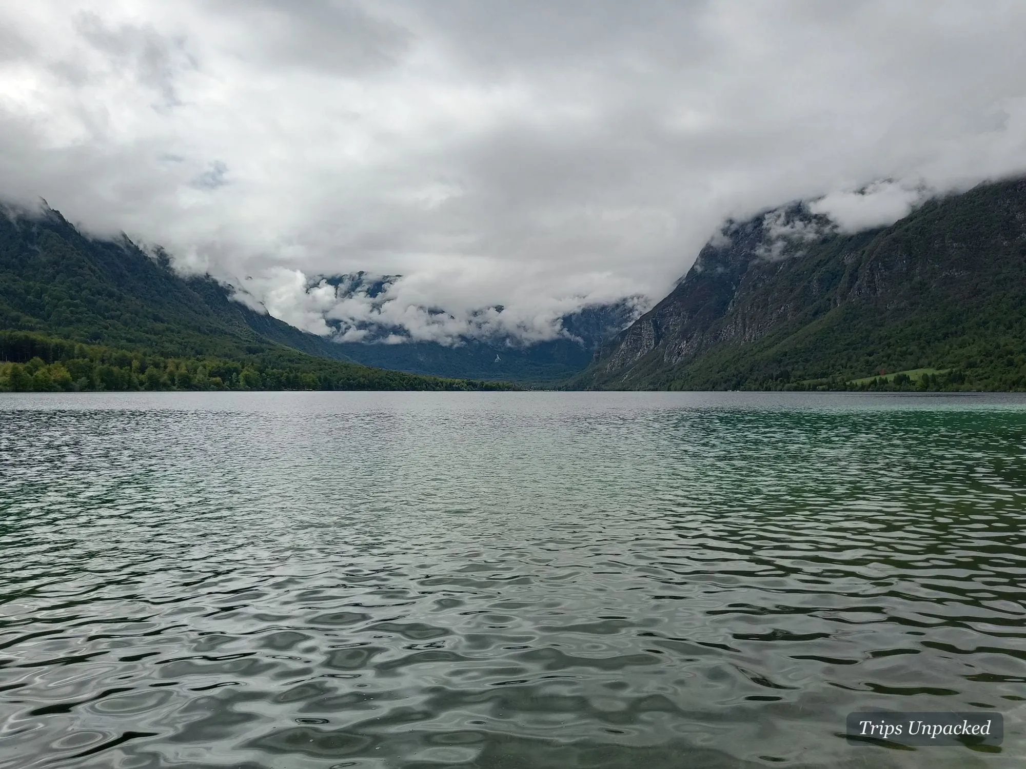 Lake Bohinj, its mountains wrapped in low cloud.