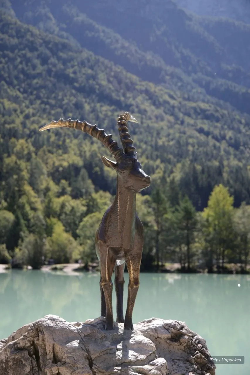 The golden-horned ibex statue on its rock at the edge of Lake Jasna.
