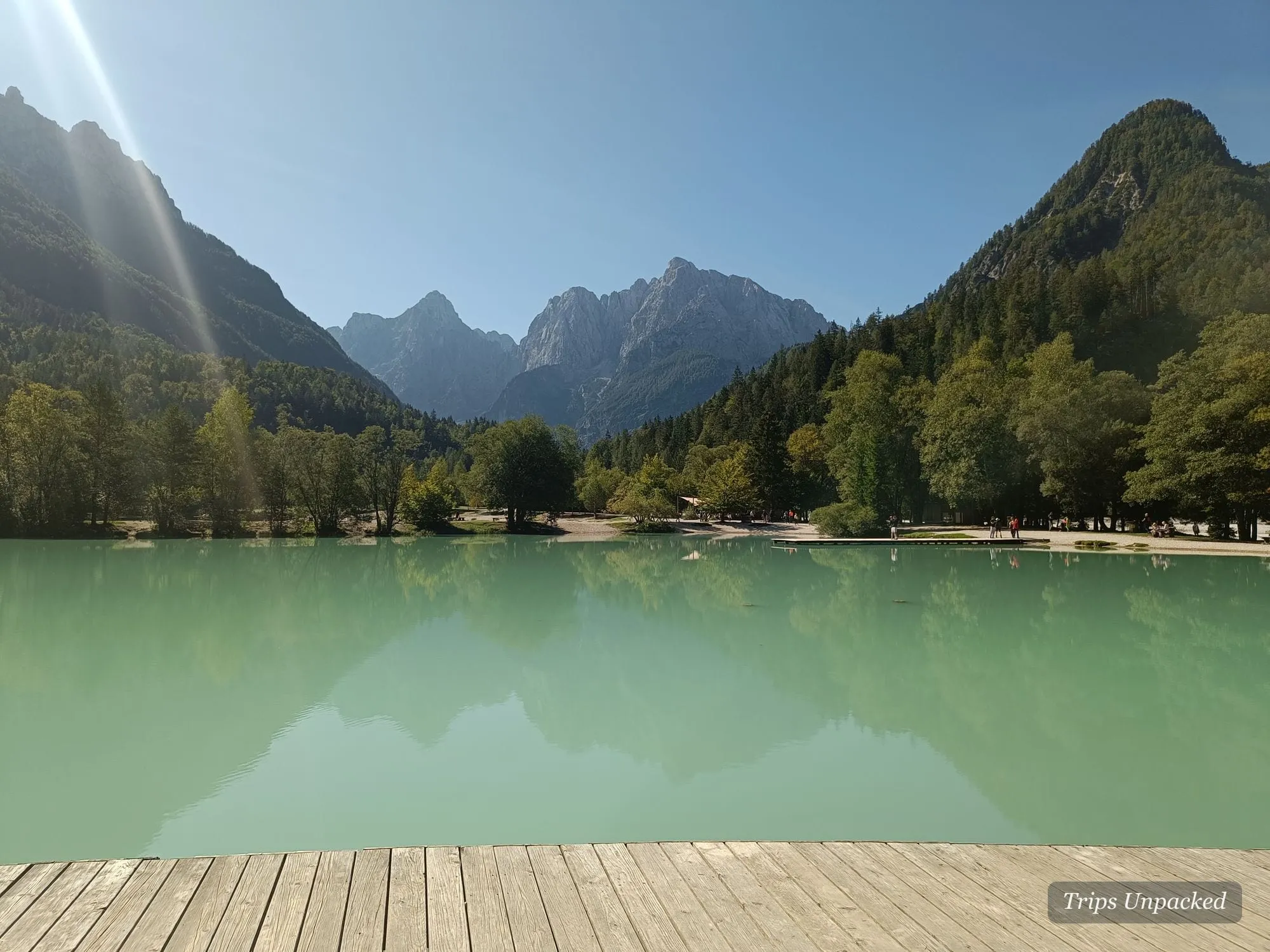 Lake Jasna's turquoise water and wooden boardwalk below the Julian Alps.